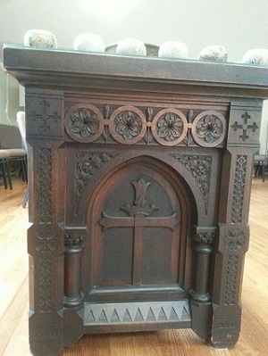 Ornately carved wooden table with solid sides