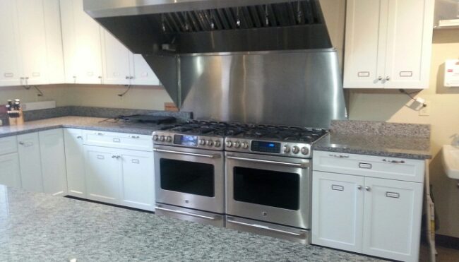 Kitchen with two ovens with range tops.