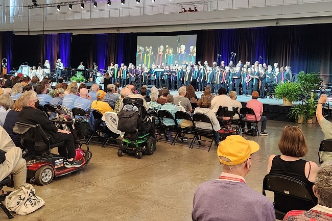 A choir stands upon a raised platform.