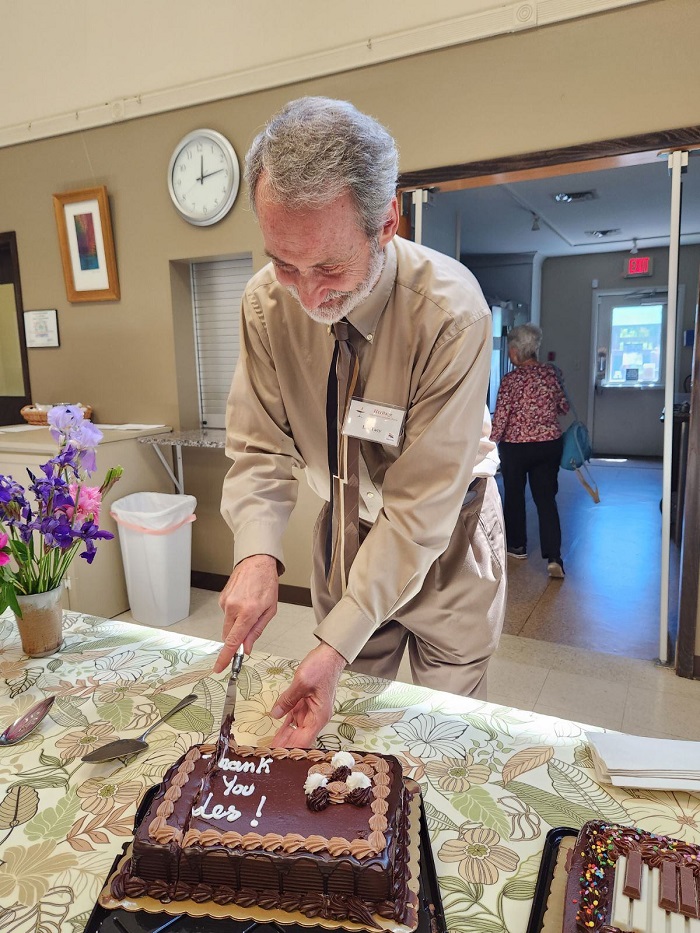 A man cuts a cake.