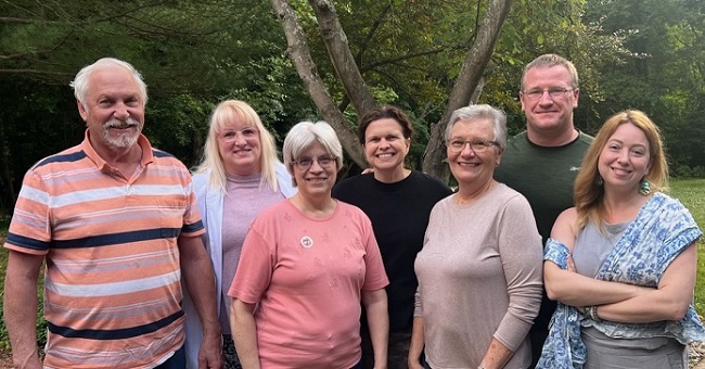 Seven people standing outside for a picture.